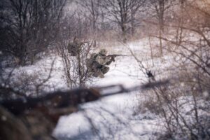 Ukrainian defenders in intense frontline clashes on Jan 4, 2026 with drones overhead and explosive artillery strikes in sight.