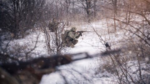 Ukrainian defenders in intense frontline clashes on Jan 4, 2026 with drones overhead and explosive artillery strikes in sight.