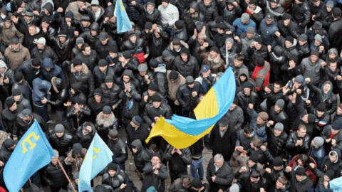 Ukrainian flags and supporters gather on Feb 26 for the Day of Resistance to Crimea’s occupation, symbolizing national unity and unbroken defiance.