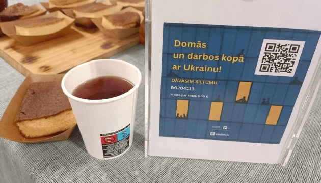 People gathered at the Point of Resilience in central Riga with a charity tent for warmth, meals, phone charges and fundraising for Ukraine support