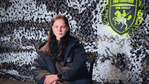 Portrait of a 19-year-old Ukrainian UGV operator in combat gear holding a drone used to evacuate a wounded comrade under fire.