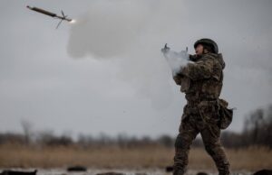 Ukrainian soldiers and armored vehicles advancing amid smoke and explosions during ongoing Russia-Ukraine war conflicts in 2026