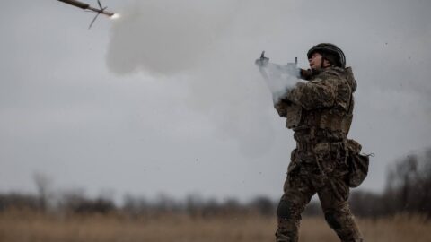 Ukrainian soldiers and armored vehicles advancing amid smoke and explosions during ongoing Russia-Ukraine war conflicts in 2026
