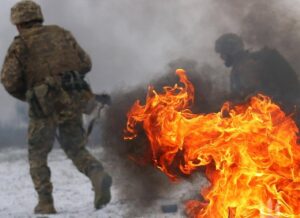 Ukrainian defenders and frontline vehicles amid smoke and explosions as mass drone and missile strikes unfold during February 17, 2026 Russia-Ukraine conflict escalation.