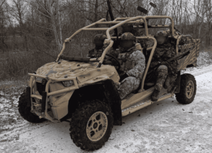 Ukrainian special forces soldier operating near frozen Dnipro river frontline with drones overhead and combat conditions in winter