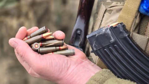 Ukrainian city after Russian drone strike with damaged buildings, smoke rising, and emergency crews responding to destruction