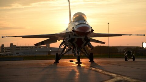 F-16 fighter jet and European flags symbolizing Belgium and Spain military aid package to Ukraine including air defense support