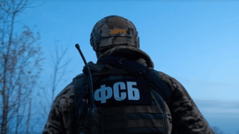 Masked armed personnel detaining a civilian in occupied Crimea, illustrating enforced disappearances under Russian control