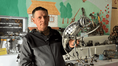 Ukrainian veteran creating techno art sculpture from scrap metal in workshop showing welding tools and recycled materials