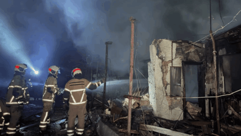 Emergency responders at damaged residential buildings after a Russian strike on Odesa that injured seven civilians