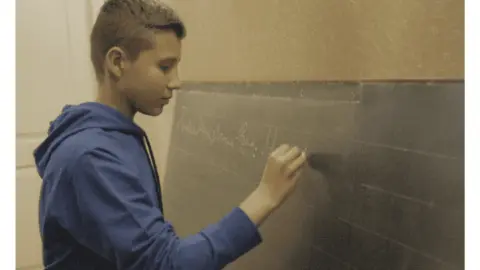 Bucha Blackboard Barcelona exhibit featuring a school blackboard from occupied Bucha with a child's testimony
